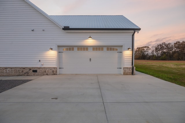 view of garage at dusk