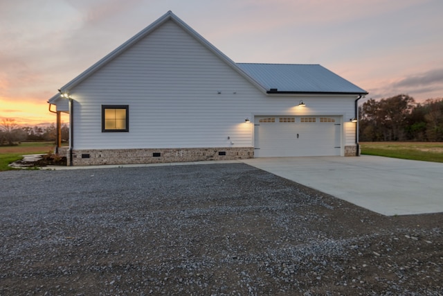 property exterior at dusk with a garage