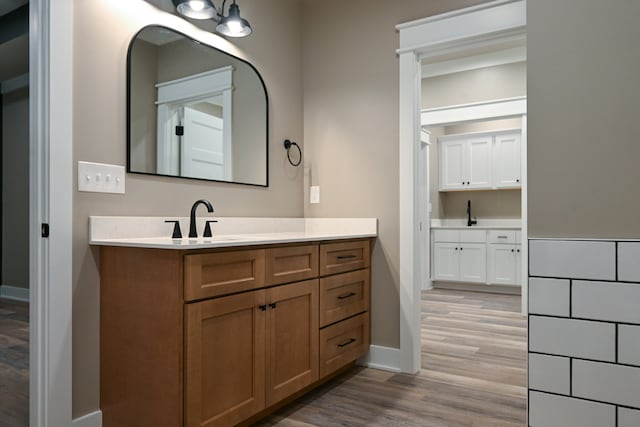 bathroom with hardwood / wood-style floors and vanity