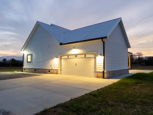 property exterior at dusk with a garage