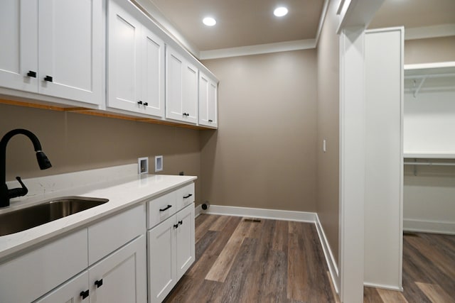 laundry area with washer hookup, cabinets, sink, and dark hardwood / wood-style floors