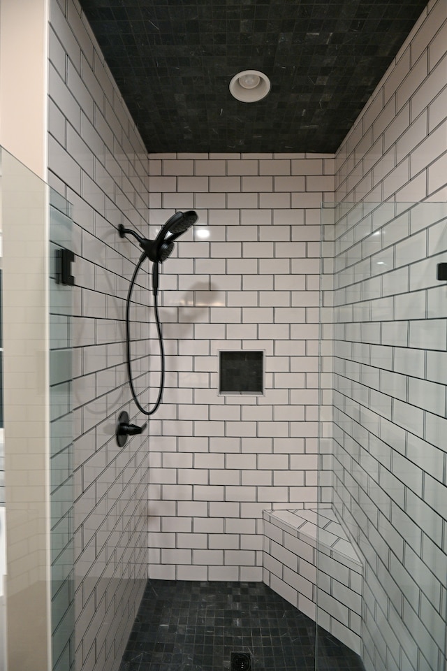 bathroom with a tile shower