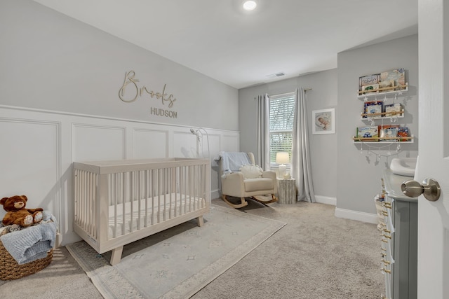 carpeted bedroom with a crib