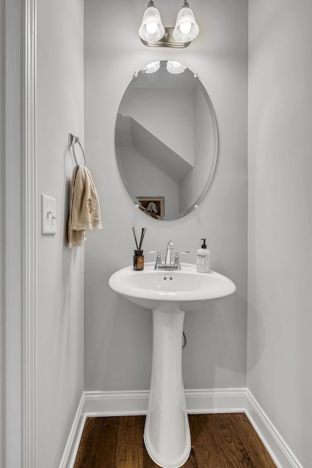 bathroom with hardwood / wood-style flooring and sink