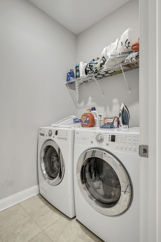 laundry room with washing machine and clothes dryer