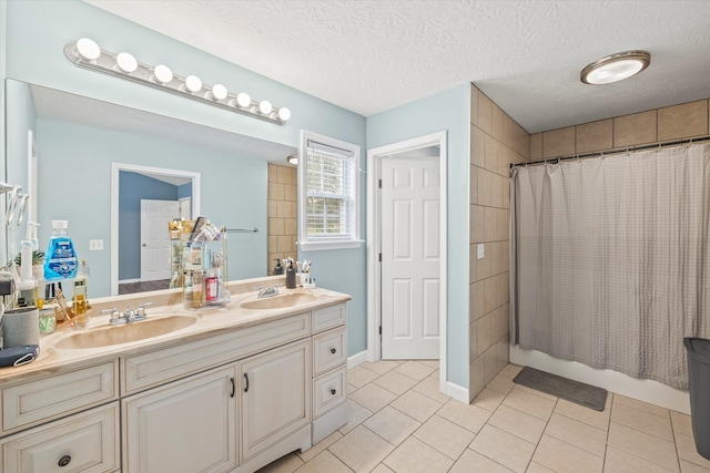 bathroom featuring shower / tub combo, tile patterned floors, vanity, and a textured ceiling