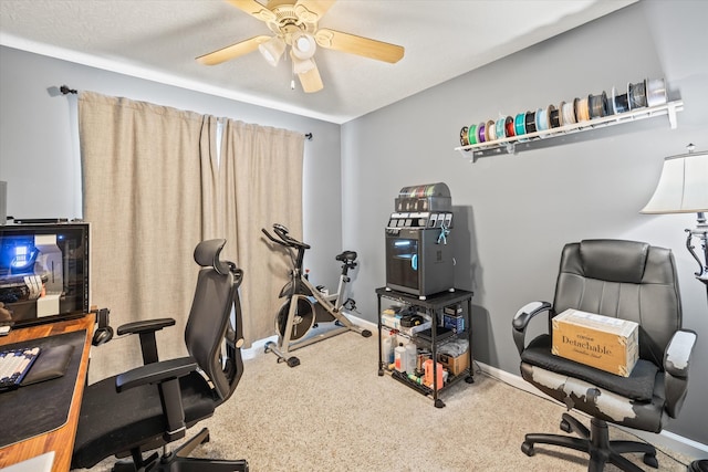 carpeted home office with ceiling fan and a textured ceiling