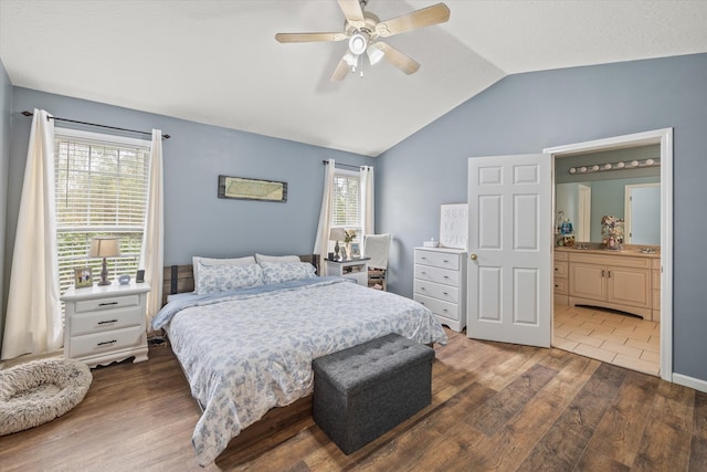 bedroom featuring multiple windows, ceiling fan, vaulted ceiling, and dark hardwood / wood-style floors