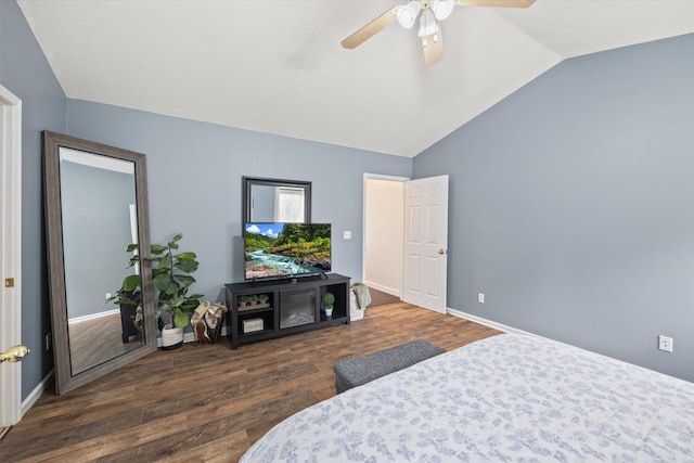 bedroom with dark hardwood / wood-style floors, vaulted ceiling, and ceiling fan