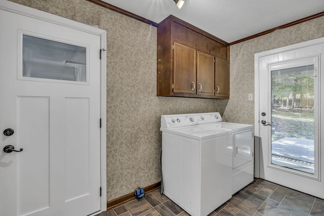 washroom with washing machine and dryer, cabinets, ornamental molding, and a textured ceiling