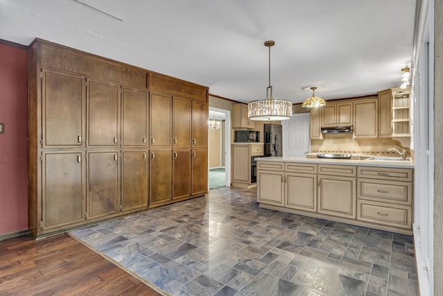 kitchen featuring black appliances, dark hardwood / wood-style floors, tasteful backsplash, sink, and hanging light fixtures