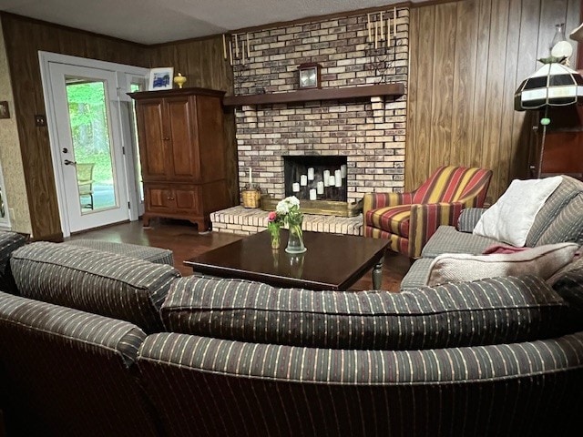 living room featuring hardwood / wood-style flooring, a brick fireplace, and wood walls