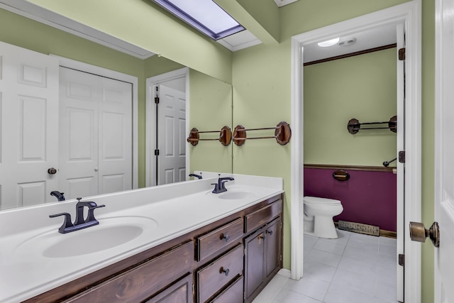 bathroom with vanity, tile patterned flooring, toilet, and crown molding