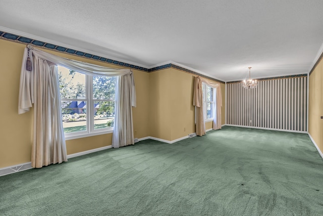 carpeted empty room featuring crown molding, an inviting chandelier, and a textured ceiling