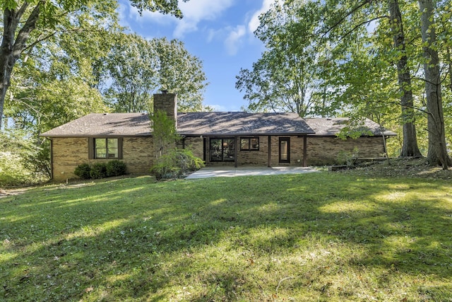 back of house with a yard and a patio area