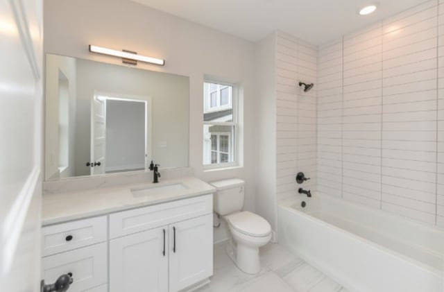 full bathroom featuring vanity, toilet, and tiled shower / bath combo