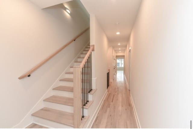 stairway with hardwood / wood-style floors