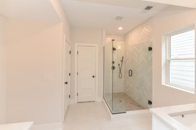 bathroom featuring an enclosed shower and tile patterned floors