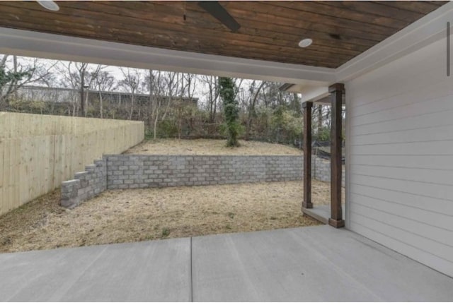 view of yard with ceiling fan and a patio