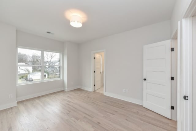 spare room featuring light hardwood / wood-style floors