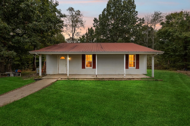 view of front of home with a yard and covered porch