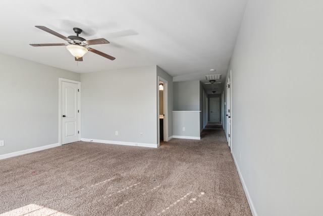 carpeted spare room featuring ceiling fan