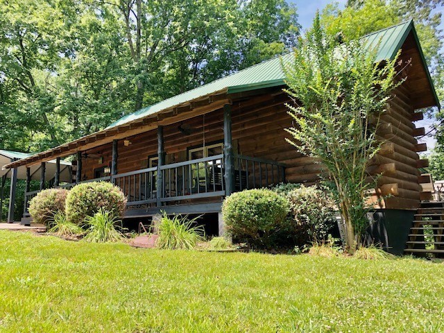 view of side of home featuring a lawn