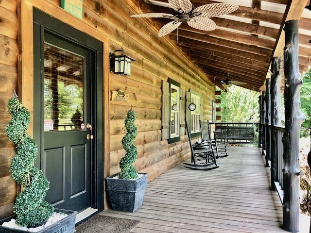 deck featuring ceiling fan and covered porch