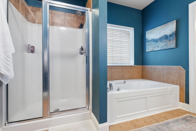 bathroom with separate shower and tub and tile patterned floors