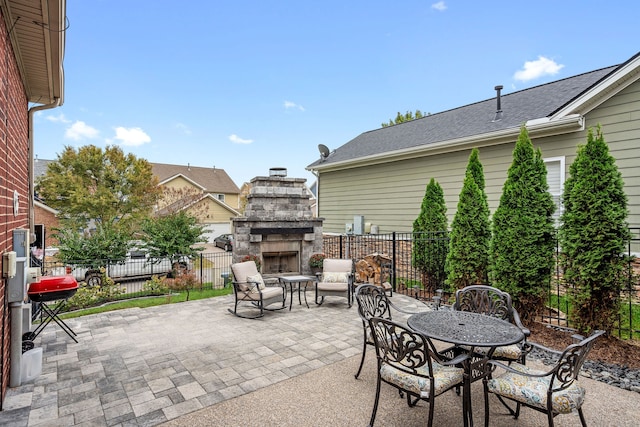 view of patio featuring an outdoor stone fireplace