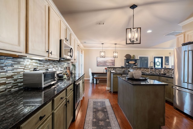 kitchen featuring a center island, dark hardwood / wood-style floors, tasteful backsplash, appliances with stainless steel finishes, and decorative light fixtures