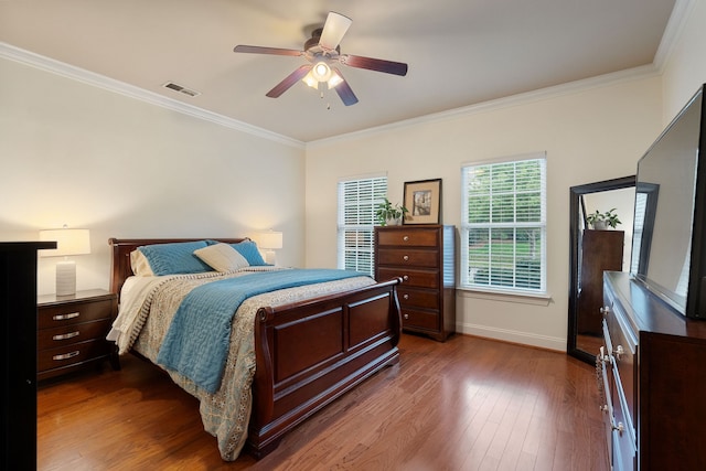 bedroom with ceiling fan, crown molding, and dark hardwood / wood-style flooring