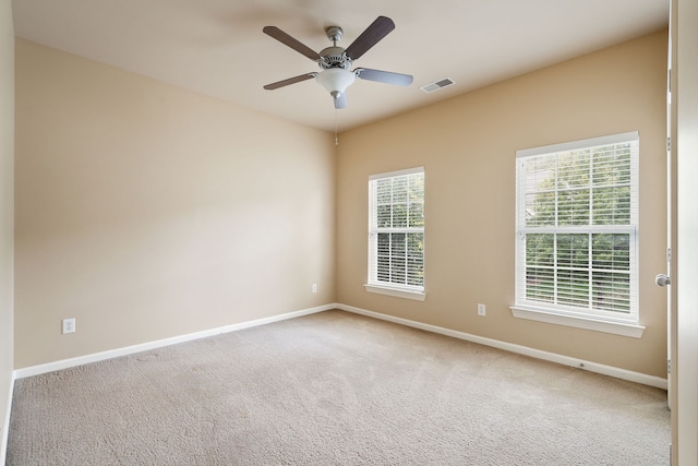 spare room featuring carpet flooring and ceiling fan