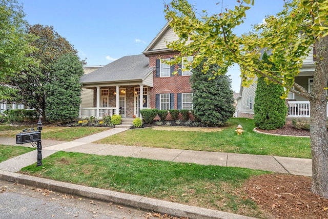 view of front facade with a front yard and a porch