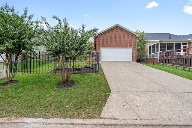 view of front of house with a sunroom, a front yard, and a garage