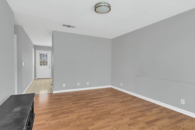 unfurnished room with wood-type flooring