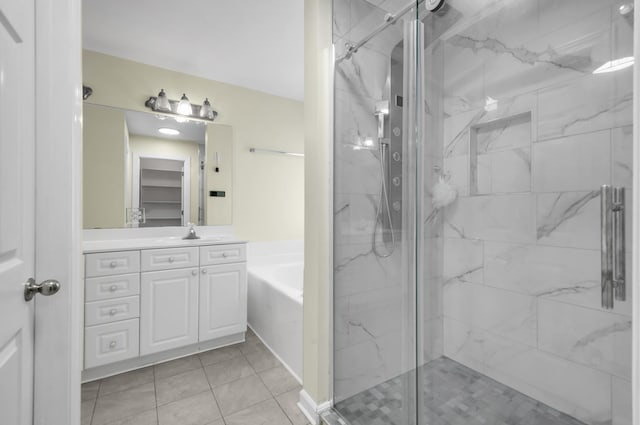 bathroom with tile patterned flooring, vanity, and separate shower and tub