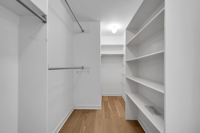 spacious closet with light hardwood / wood-style floors