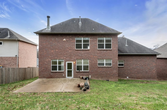 back of property featuring a lawn and a patio