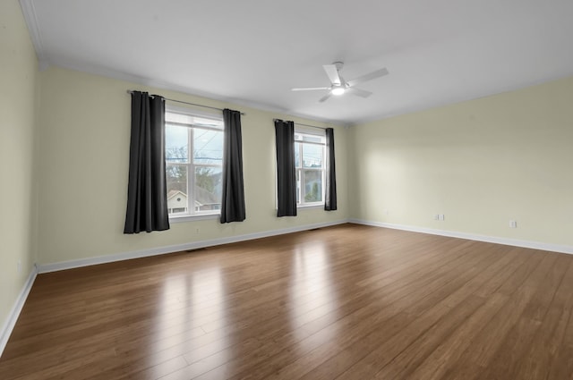 unfurnished room with hardwood / wood-style flooring, ceiling fan, and crown molding