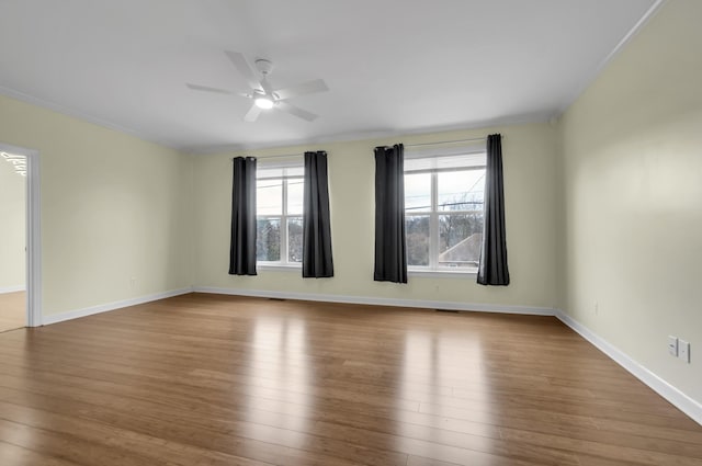 unfurnished room featuring ceiling fan, hardwood / wood-style floors, and crown molding