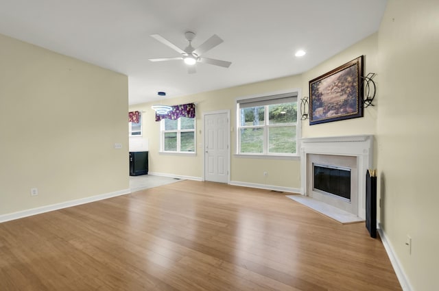 unfurnished living room with ceiling fan and light hardwood / wood-style floors