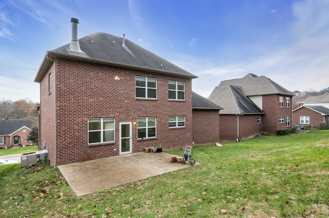 back of property featuring a lawn and a patio area