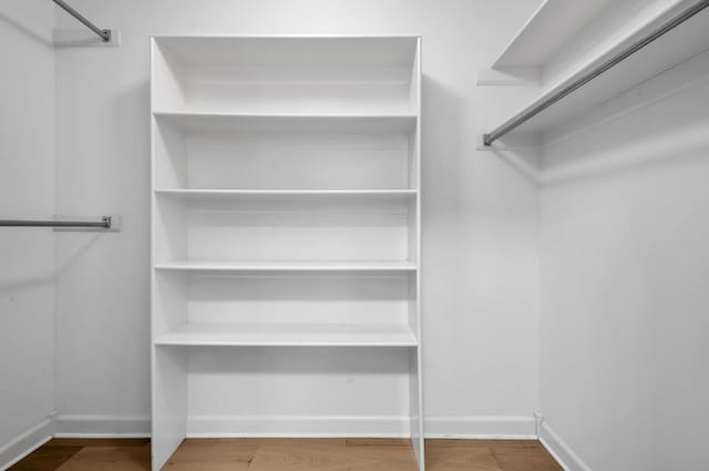 spacious closet featuring hardwood / wood-style floors