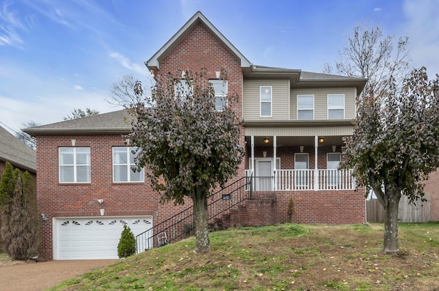 view of front property with a porch and a garage