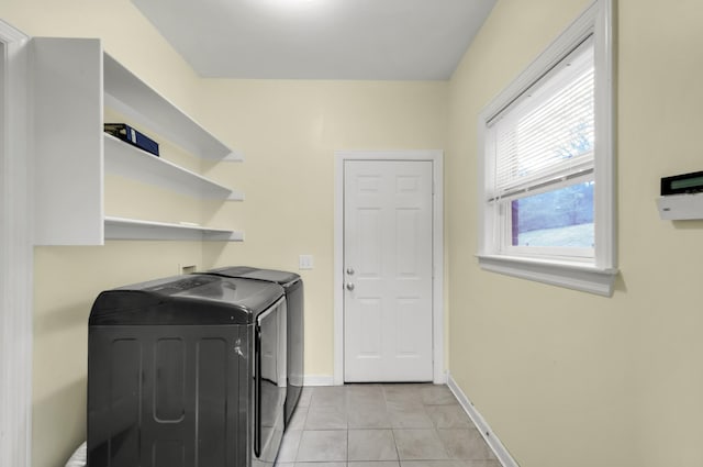 washroom featuring separate washer and dryer and light tile patterned flooring