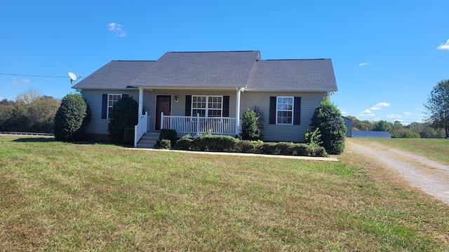 view of front facade featuring a front yard and covered porch