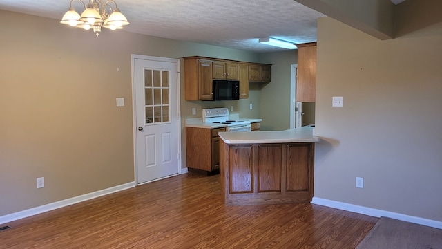 kitchen featuring white electric range oven, a chandelier, dark hardwood / wood-style flooring, and a textured ceiling