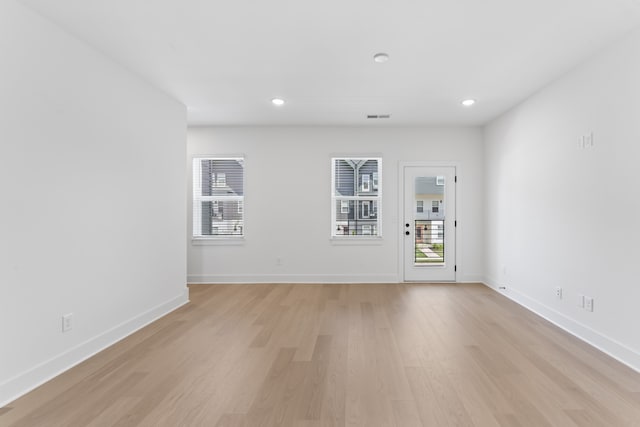 empty room with light hardwood / wood-style flooring