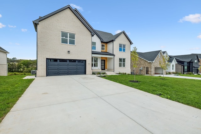 view of front of property with a front yard and a garage